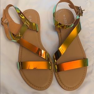 Gold metallic sandals .